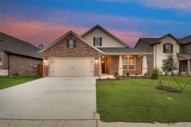 view of front of house featuring a garage and a lawn