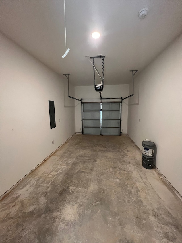 garage featuring electric panel and a garage door opener