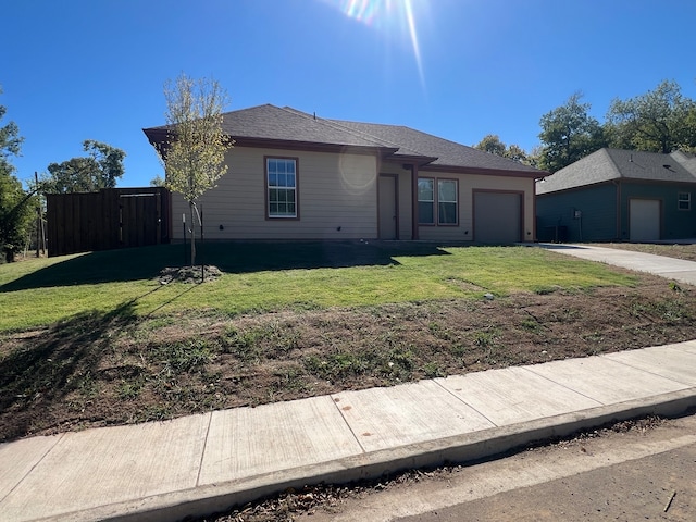 single story home with a front lawn and a garage