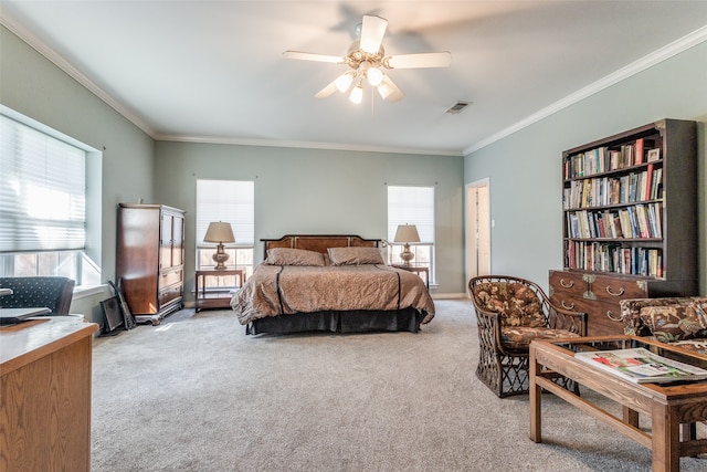 carpeted bedroom with crown molding and ceiling fan