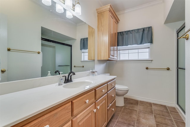 bathroom with ornamental molding, vanity, toilet, a healthy amount of sunlight, and tile patterned floors