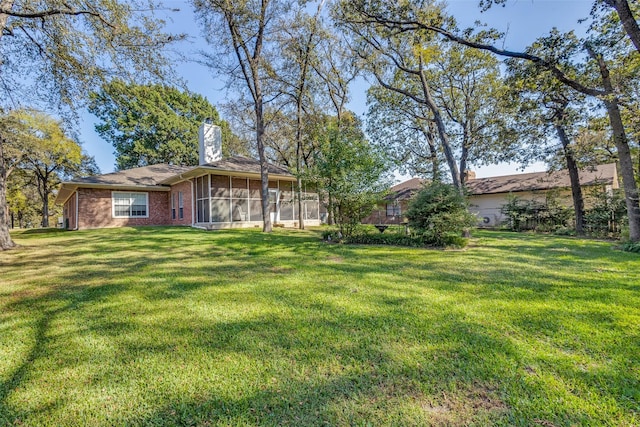 view of yard featuring a sunroom