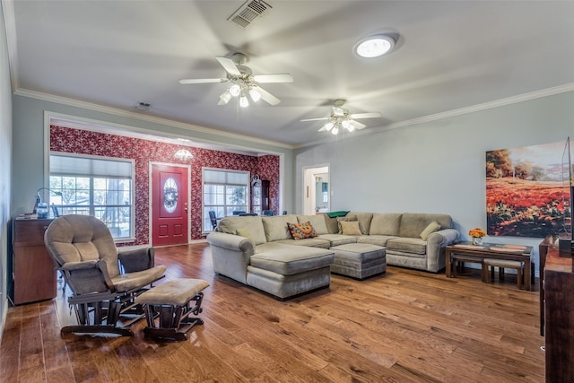 living room with hardwood / wood-style flooring, ceiling fan, and ornamental molding