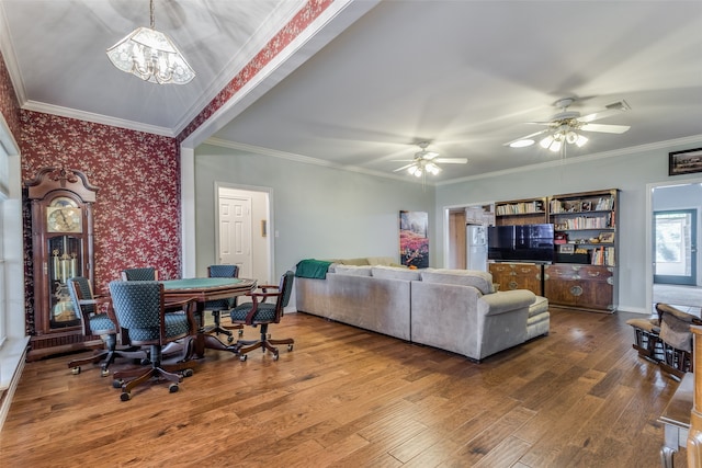 living room with crown molding, ceiling fan with notable chandelier, and hardwood / wood-style floors