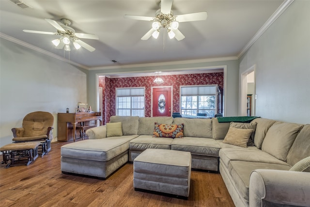 living room with dark hardwood / wood-style flooring, crown molding, and ceiling fan