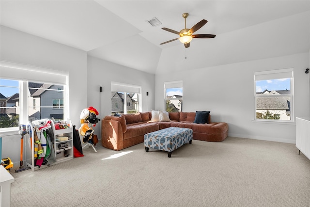 carpeted living room featuring ceiling fan and vaulted ceiling