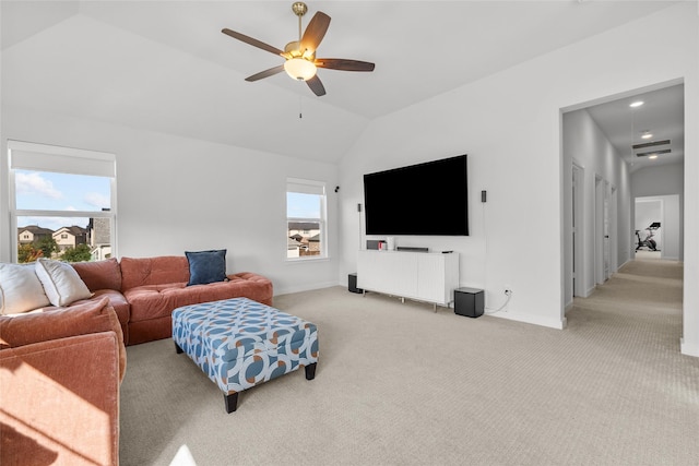 living room featuring ceiling fan, light carpet, and vaulted ceiling