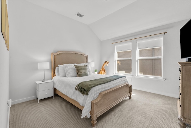 carpeted bedroom with vaulted ceiling