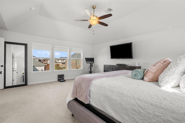 carpeted bedroom with a raised ceiling, ceiling fan, and lofted ceiling