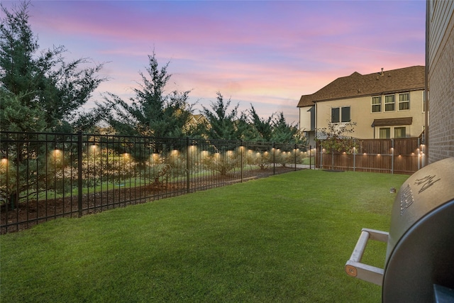 view of yard at dusk