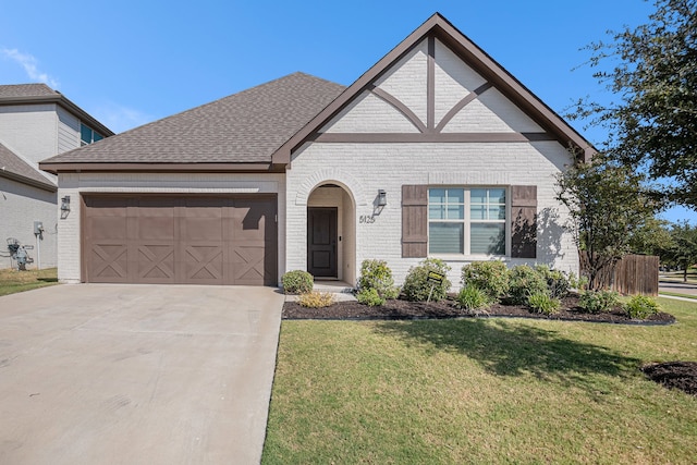 view of front of home featuring a front yard and a garage