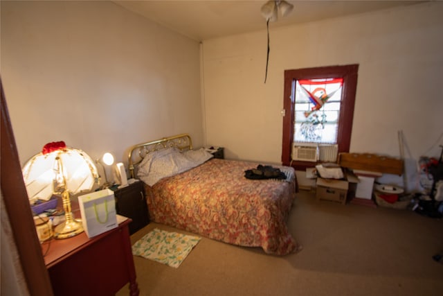 carpeted bedroom featuring ceiling fan and cooling unit