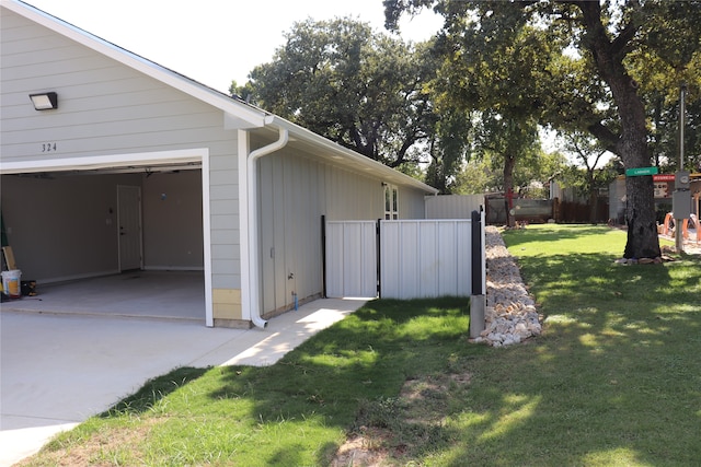 view of home's exterior featuring a garage and a yard