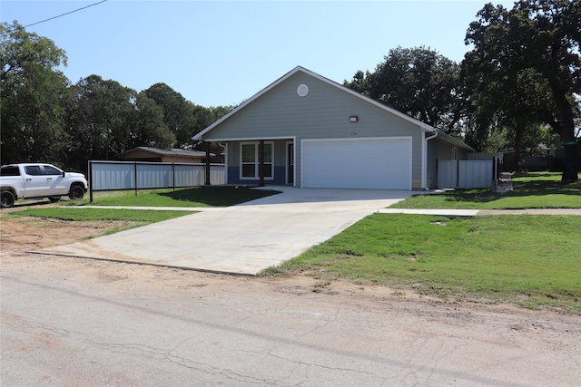 view of front of property featuring a front yard and a garage