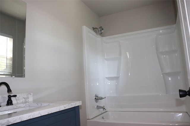 bathroom with vanity and shower / washtub combination