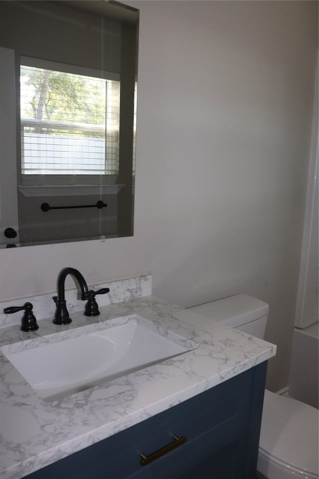 bathroom featuring vanity and toilet