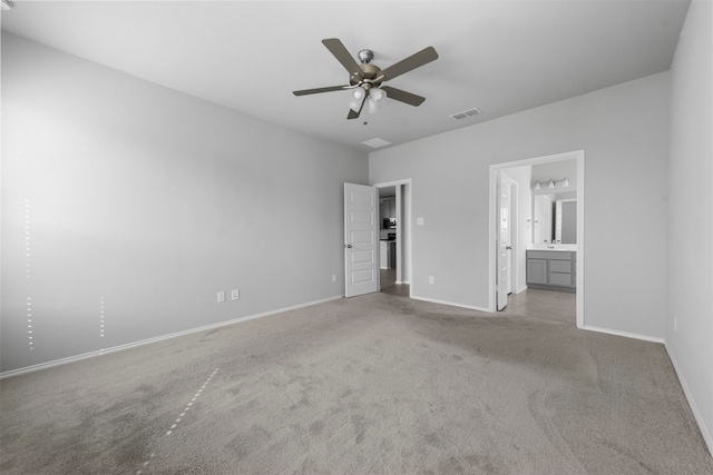 unfurnished bedroom with ceiling fan, light carpet, and ensuite bathroom