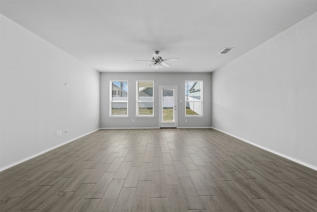 empty room with dark hardwood / wood-style flooring and ceiling fan