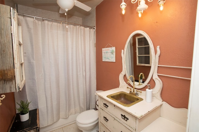 full bathroom with ceiling fan, vanity, shower / bath combination with curtain, tile patterned flooring, and toilet