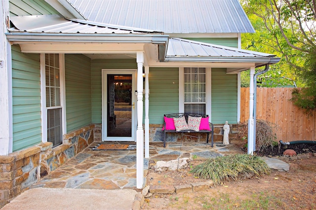 view of exterior entry featuring a patio area