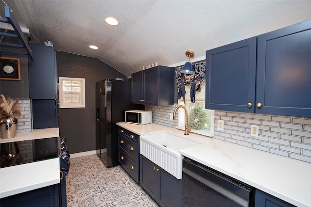 kitchen featuring lofted ceiling, black appliances, sink, and blue cabinets