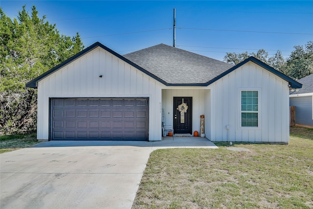 view of front of house featuring a garage and a front yard