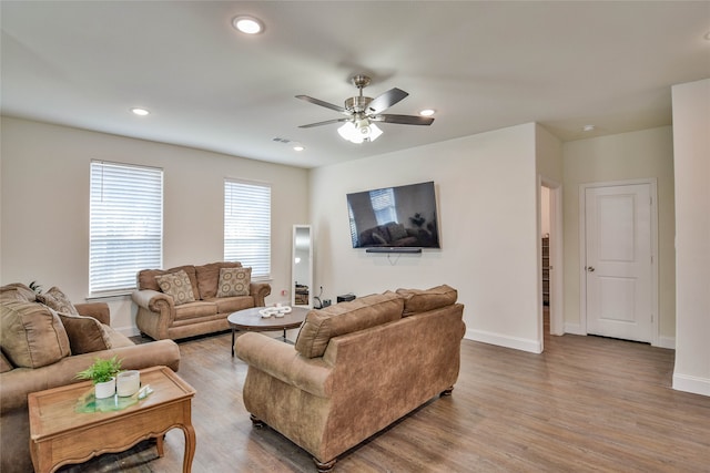 living room with hardwood / wood-style flooring and ceiling fan