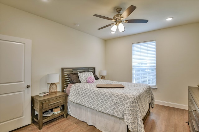 bedroom with ceiling fan and light wood-type flooring