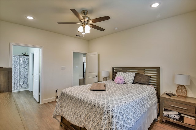 bedroom with ceiling fan, hardwood / wood-style flooring, and ensuite bathroom