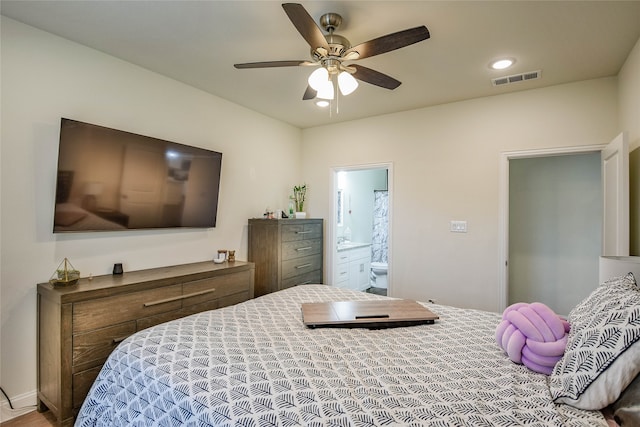 bedroom with ensuite bathroom and ceiling fan