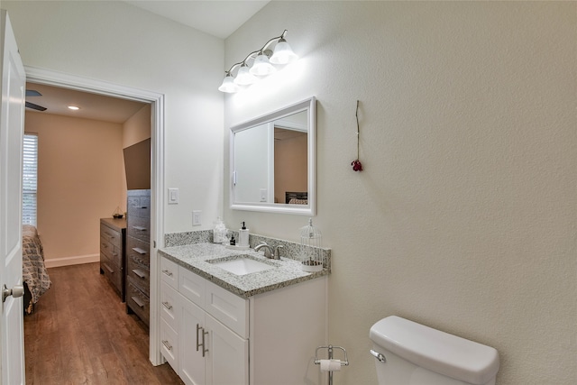 bathroom featuring vanity, toilet, and wood-type flooring