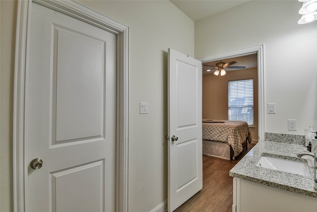 bathroom with ceiling fan, vanity, and hardwood / wood-style floors