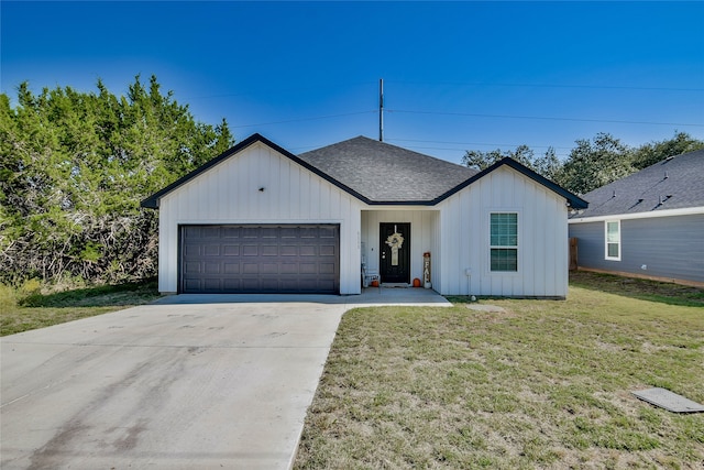 modern farmhouse style home with a garage and a front lawn