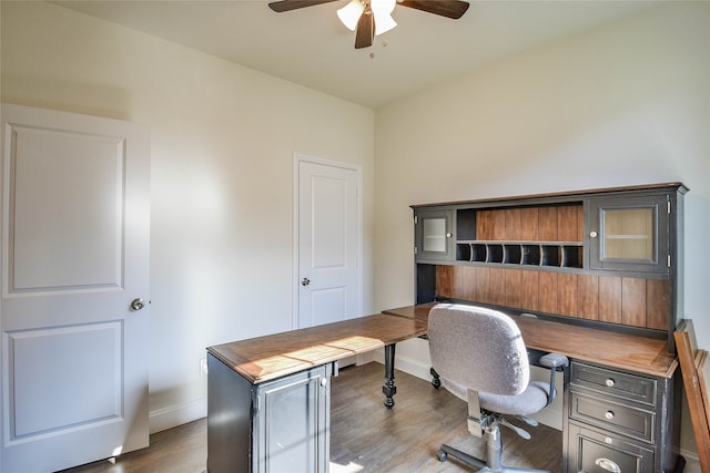 home office with ceiling fan and hardwood / wood-style floors