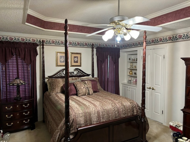 bedroom featuring ceiling fan, ornamental molding, a textured ceiling, and light colored carpet