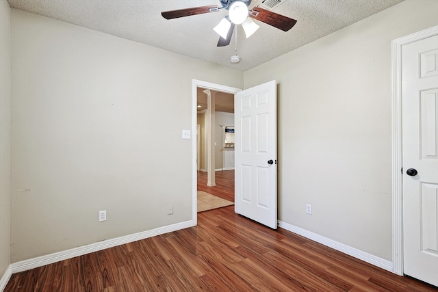 unfurnished bedroom featuring hardwood / wood-style floors, a textured ceiling, and ceiling fan