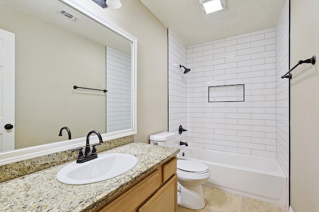 full bathroom with vanity, tiled shower / bath, tile patterned flooring, toilet, and a textured ceiling