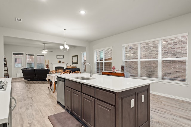 kitchen with light hardwood / wood-style floors, dishwasher, sink, and a wealth of natural light