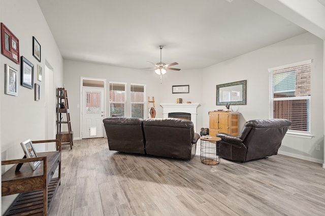 living room featuring light hardwood / wood-style flooring and ceiling fan