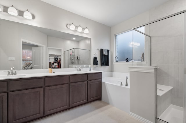 bathroom featuring vanity, independent shower and bath, and tile patterned flooring