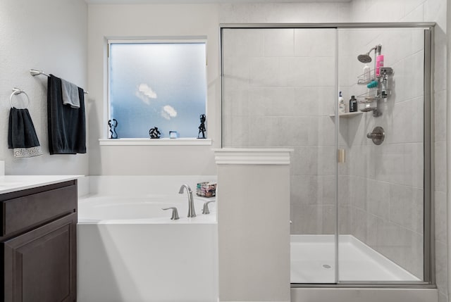 bathroom featuring vanity and shower with separate bathtub