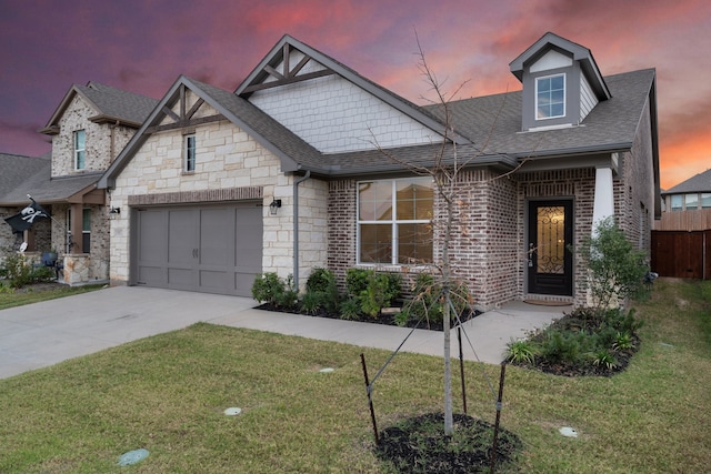 view of front of house featuring a yard and a garage