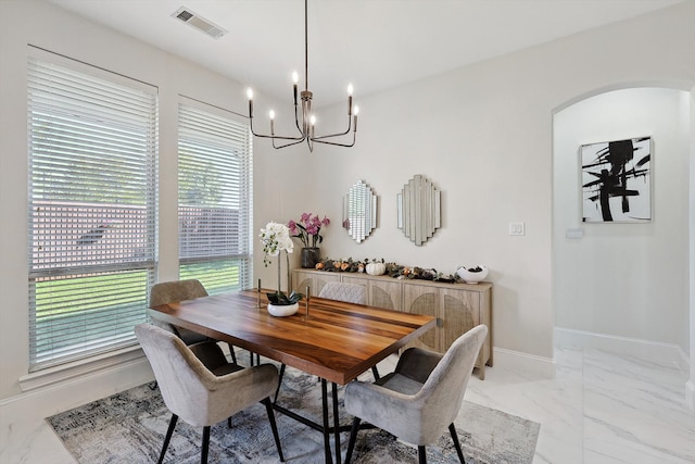 dining space featuring a notable chandelier and a wealth of natural light