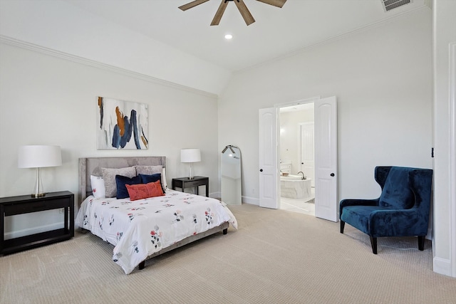 carpeted bedroom with ensuite bathroom, vaulted ceiling, and ceiling fan