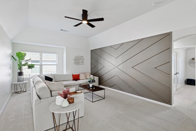 carpeted living room featuring ceiling fan and lofted ceiling