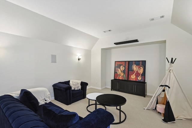 cinema with light carpet and vaulted ceiling