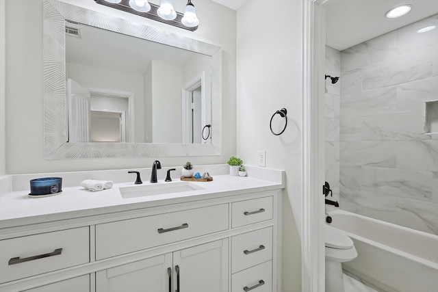 bathroom featuring vanity and tiled shower / bath