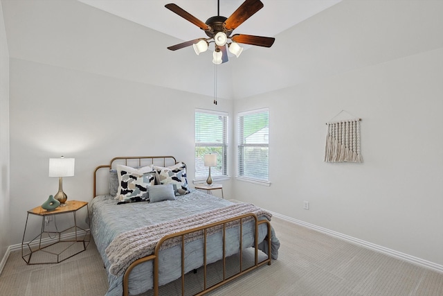 bedroom with ceiling fan, light colored carpet, and lofted ceiling