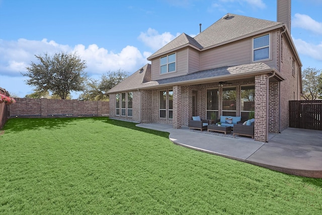 back of property featuring outdoor lounge area, a yard, and a patio