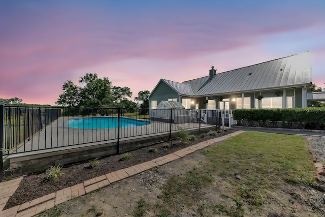 pool at dusk with a lawn